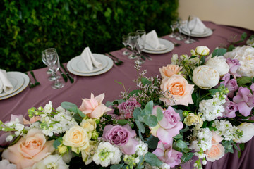 Beautiful flowers composition with pink and orange roses on table in wedding day
