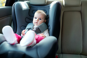 Baby exploring her car seat