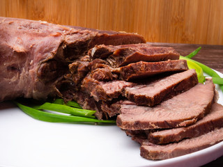 raw five pork or beef tongues with green onion, on wooden background gourment food conception, selective focus
