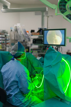 Male surgeon performing laser treatment in hospital