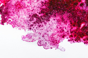 top view of pink watercolor spill on white background