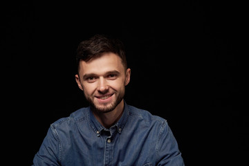 Fototapeta premium Handsome man in denim shirt looking at camera smiling