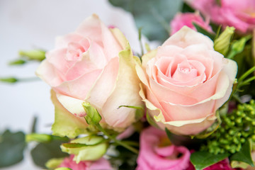 a bouquet of pink roses on a light background