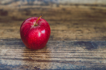 close-up of red apple on wooden table
