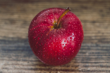 close-up of red apple on wooden table