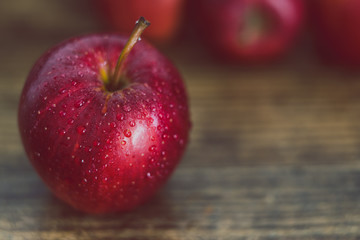 close-up of red apple on wooden table