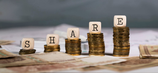 Word SHARE composed of wooden letter.