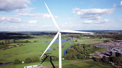 aerial view of wind turbine and agricultural fields