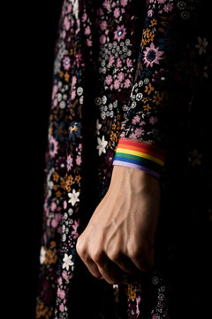 Close up of woman with rainbow patterned band on wrist