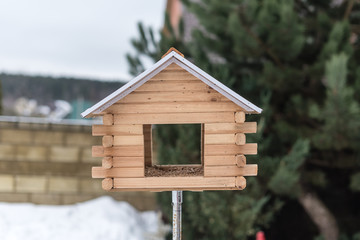 Obraz na płótnie Canvas Birdhouse for birds in the yard in winter