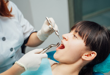Woman having teeth examined at dentists. Dental clinic