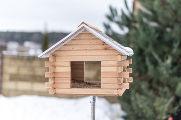Obraz na płótnie Canvas Birdhouse for birds in the yard in winter