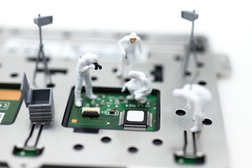 Miniature people: Workers repairing circuit board ,electronics repair. Use image for support and...