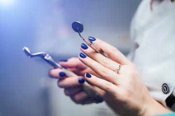 Stomatological instrument in dentists clinic. Dentist's hands holding dental tools