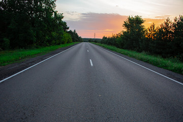 Empty straight road at sunrise