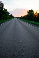 Fototapeta premium Empty straight road at sunrise