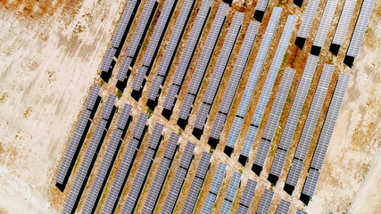 aerial top view of solar power panels in desert, solar farm energy