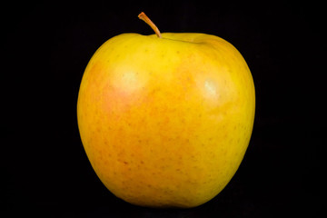 Yellow-green apple on a black background