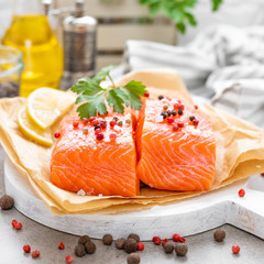 Fresh raw salmon fish fillet on white kitchen background