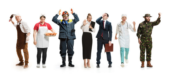 Obraz premium Workers strike concept. Collage of different professions. Group of angry men and women in uniform screaming at studio isolated on white background. Buisiness, professional concepts