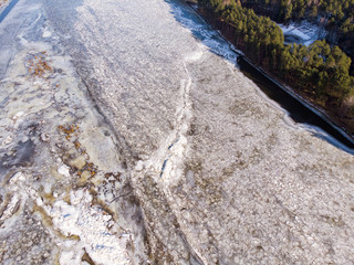 Aerial view of frozen river. Aerial view of ice. Aerial shot of river in winter.
