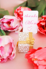 pink tulips and decorative gift box with a bow for the holiday of March 8