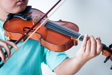 Boy playing violin in room © SUPERMAO