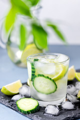 Cold and Refreshing Infused Detox Water with Lime and Cucumber in a Glass With Ice Cube Healthy Detox Drink Vertical