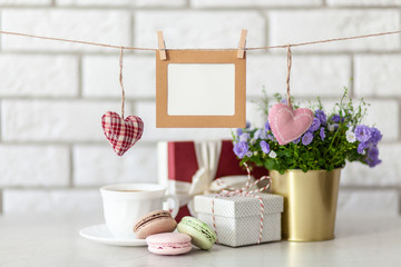 Gift boxes and flowers on white wall background