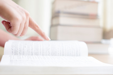 close up on finger woman pointing  a book