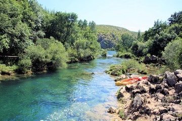 Fototapeta na wymiar kayaks and the Zrmanja river near Muskovici, Croatia