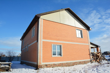 Brick house under construction in winter