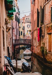 Fototapeta na wymiar Colourful pink tenement houses and Grand Canal in Venice, Italy