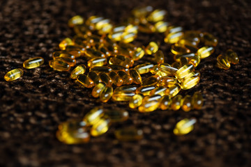 many capsules of gold color lies on the leopard skin