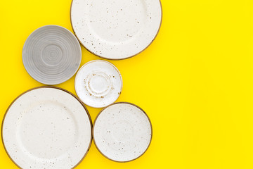 Mockup with plates. Empty ceramic plates on yellow background top view copy space