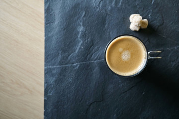 Top view of freshly brewed coffee on slate with text space