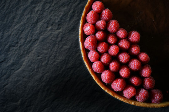 Top View Of Beautiful Raspberry And Chocolate Tart On Slate With Text Space