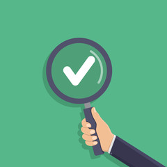 Business hand holding a magnifying glass, check mark, flat design vector illustration