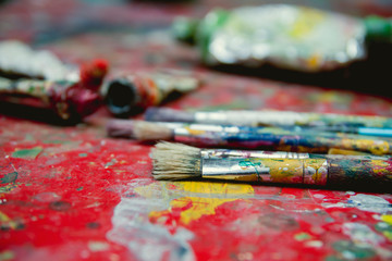 Fototapeta premium Painting brushes and oil on painter table