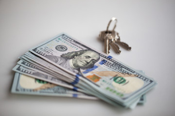 sale and rental of real estate concept. money and apartment keys
