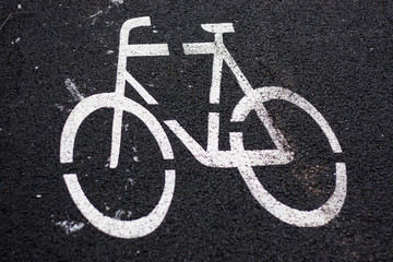 Beautiful view of bicycle sign painted on a black asphalt road.