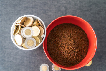 Styrofoam cup full of coins with red bowl of instant coffee