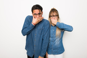 Obraz premium Young couple with glasses covering mouth with hands for saying something inappropriate