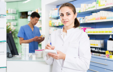 Fototapeta na wymiar Female pharmacist standing in drugstore