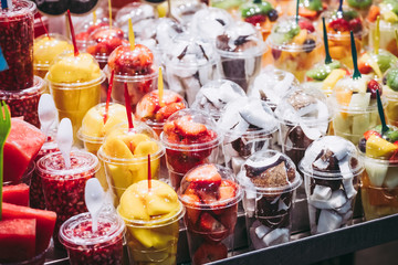 Fruits tranchés dans des gobelets en plastique sur un stand au marché de la Boqueria à Barcelone
