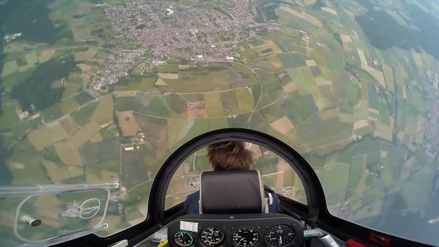 Aerobatic glider airplane in the air tail cocpit view