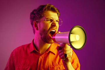 man making announcement with megaphone at gold studio