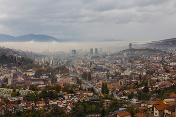 Fototapeta na wymiar View from the high point to Sarajevo in the mist in the morning. Bosnia and Herzegovina