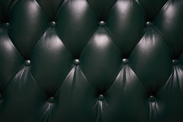 Texture of a brown leather sofa with a four-sided tie