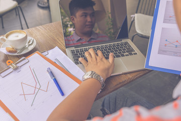 Businessman using laptop when working on financial reports
